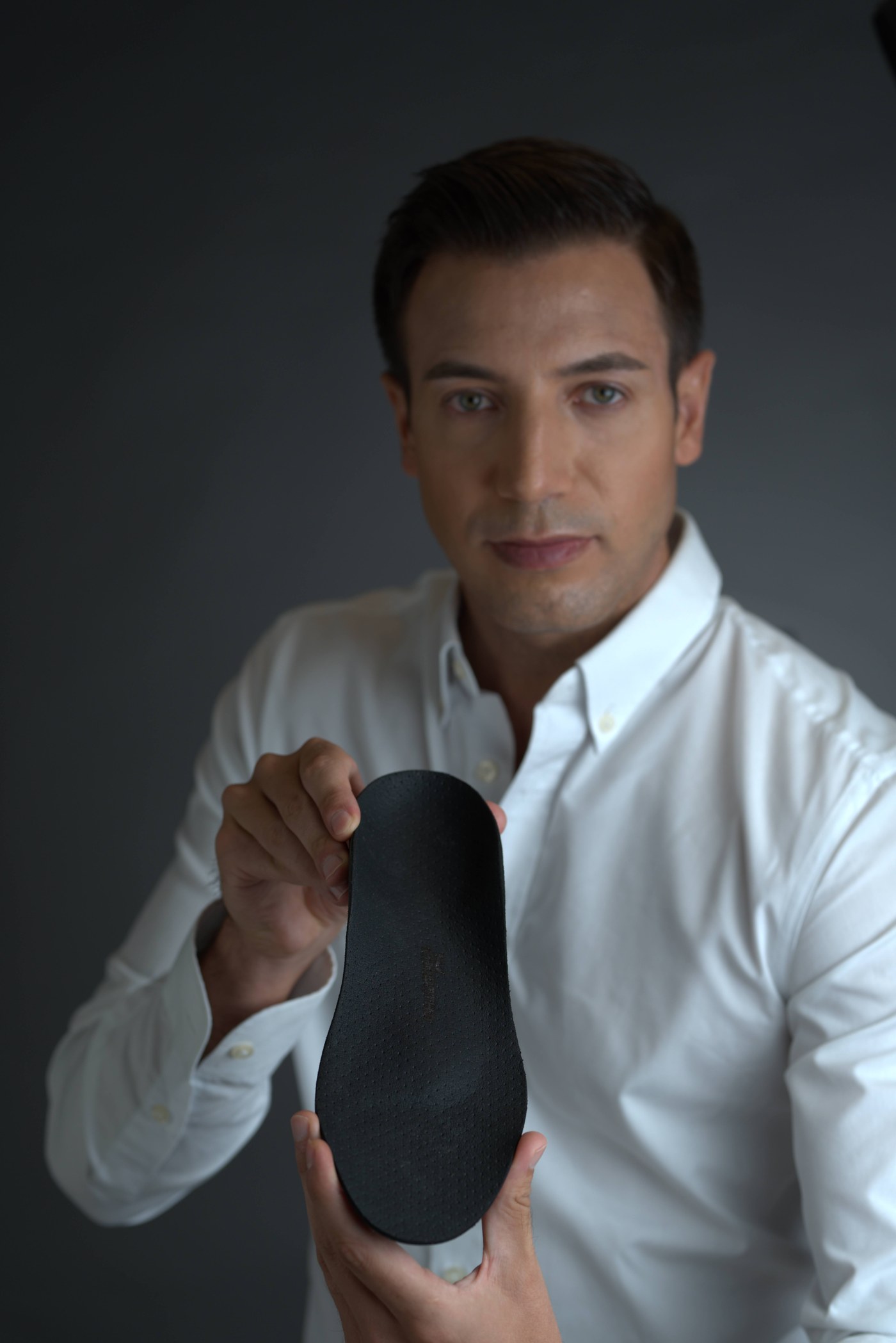 Albin Brion holding a finished carbon fibre custom-made orthotic
