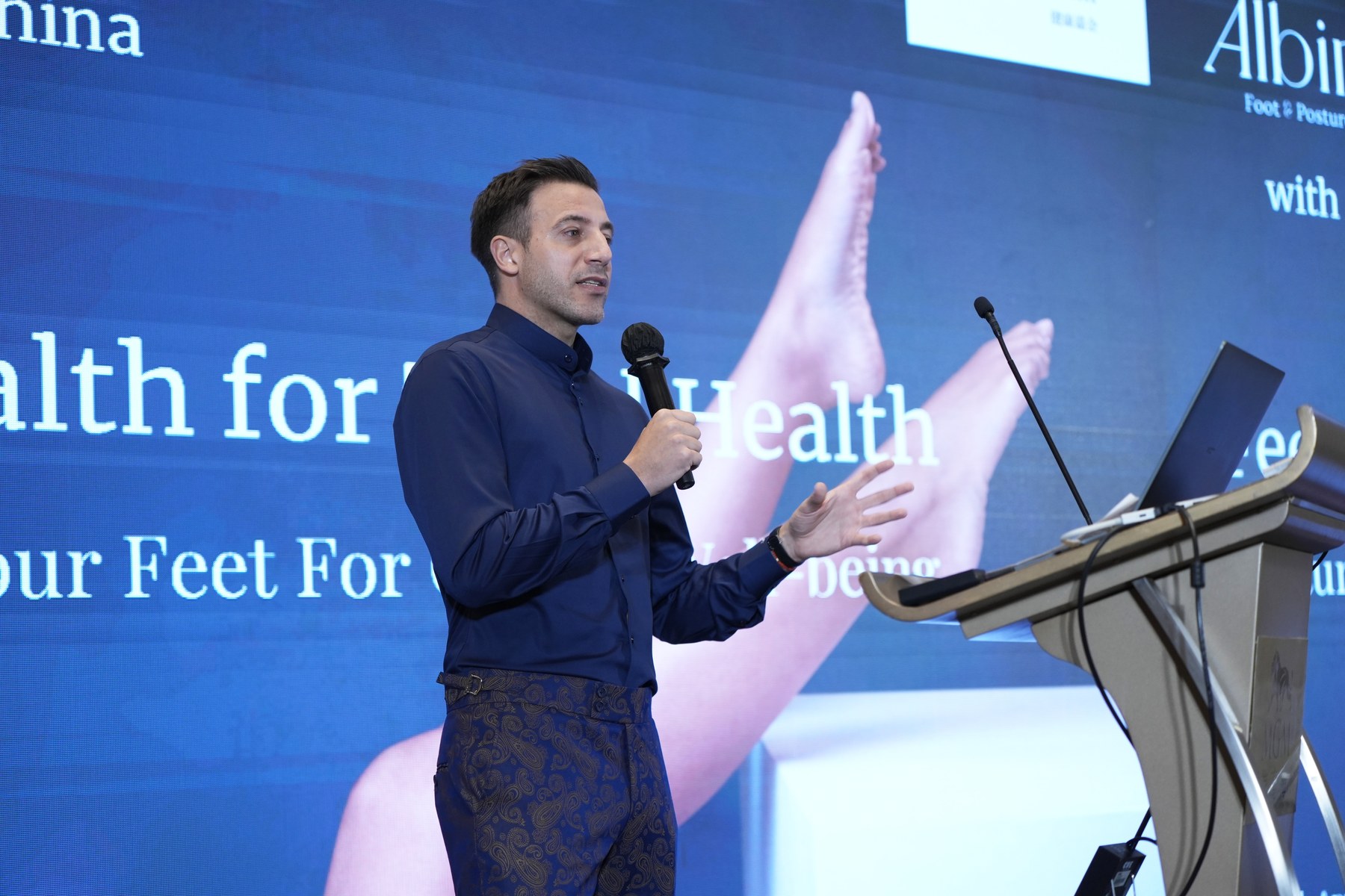 Albin Brion speaking on stage about foot health